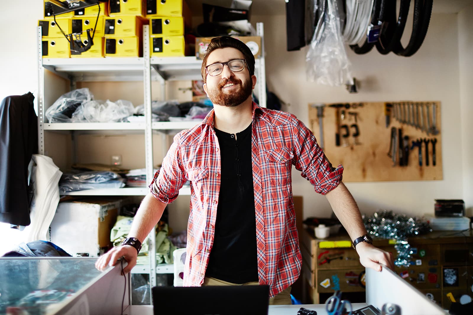 Small business owner standing in their bicycle and parts shop