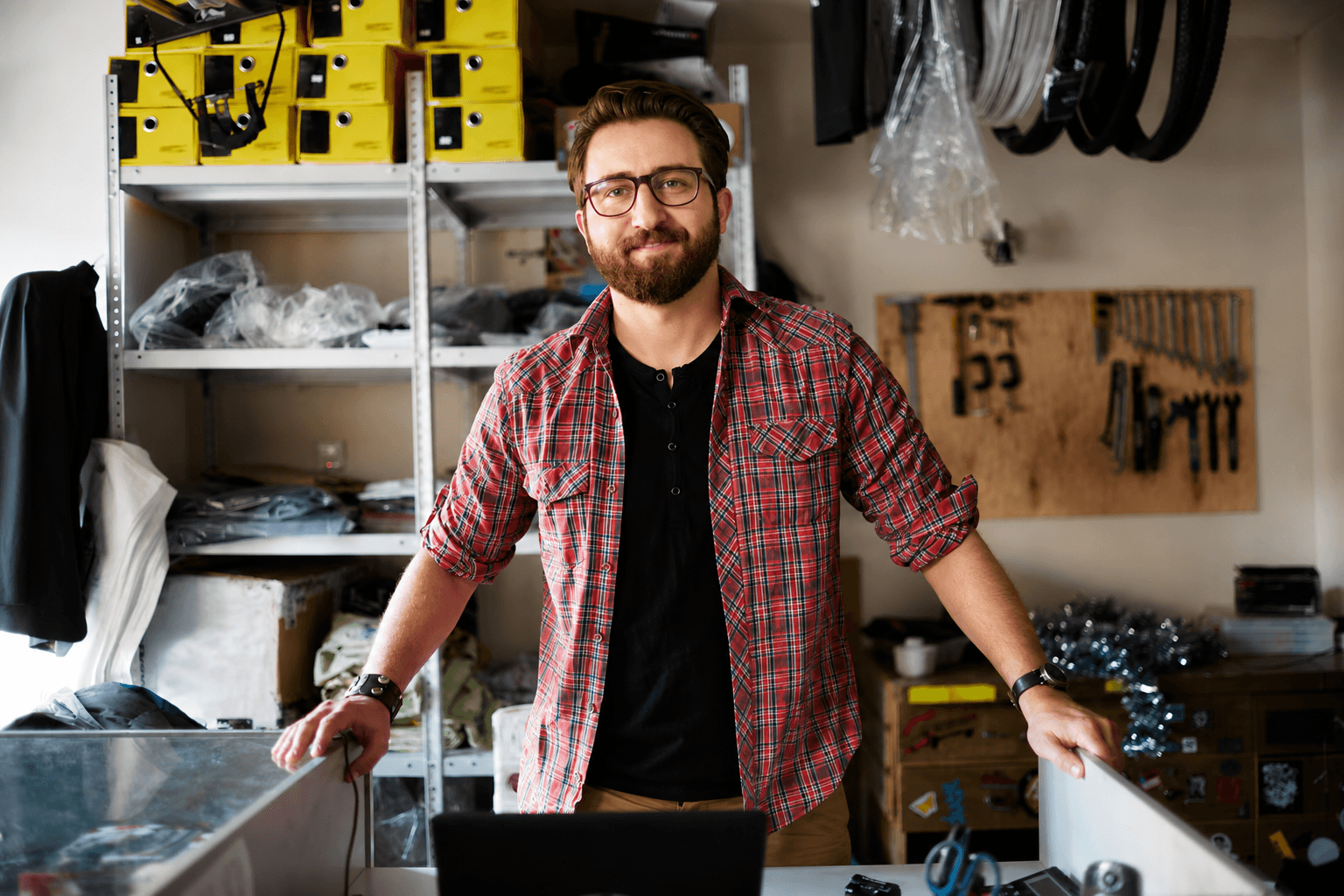 Small business owner standing in their bicycle and parts shop
